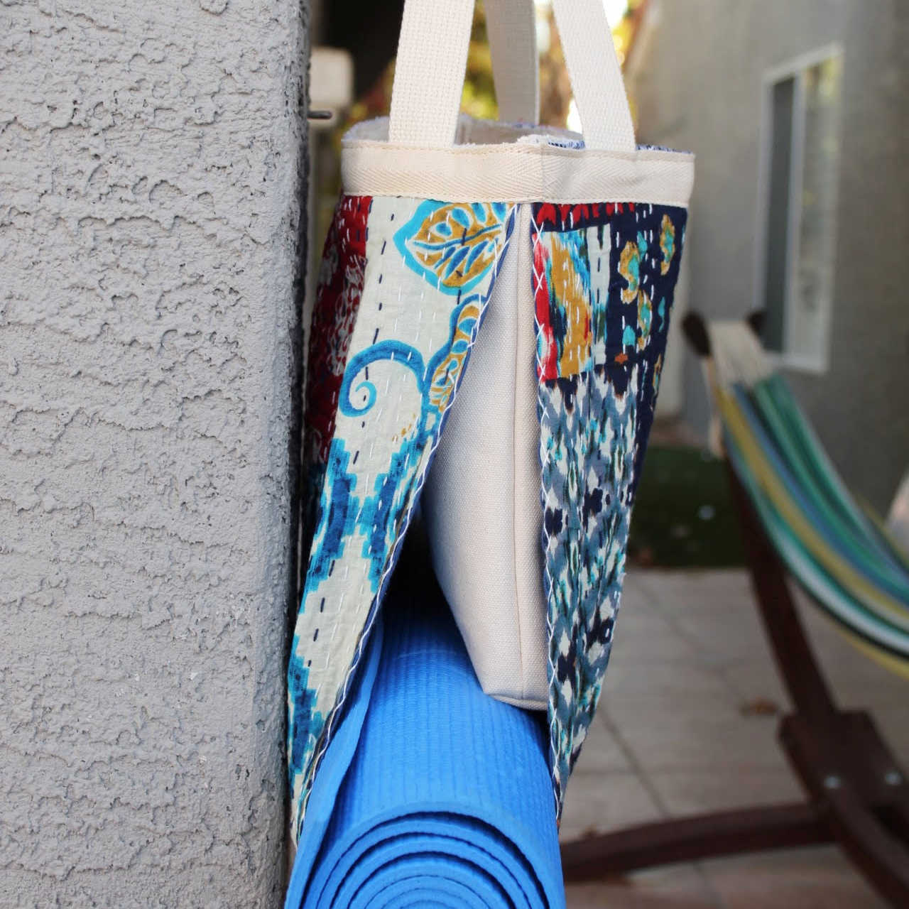 Side of Yoga Purse carrying a yoga mat and essentials to a yoga studio